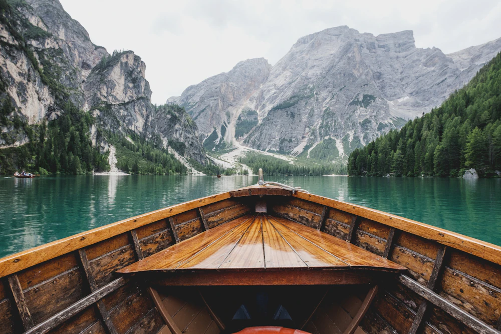 A calm alpine lake surrounded by mountains
